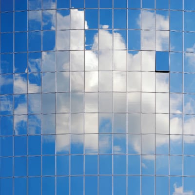 Cloudy sky reflecting off of tiled skyscraper windows