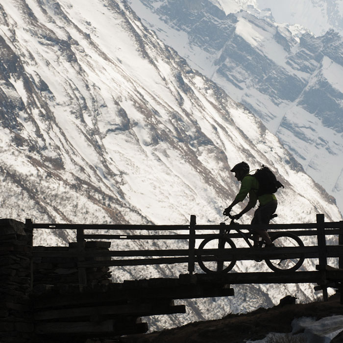 Biker on bridge over mountain
