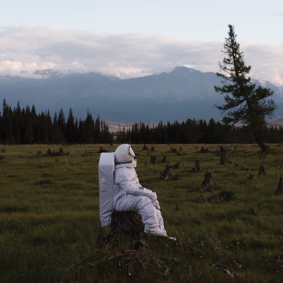 astronaut sitting in a field