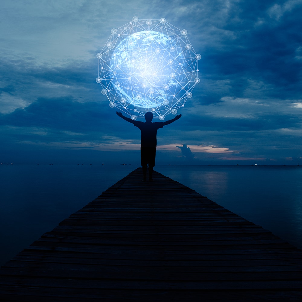 person standing under a digital globe