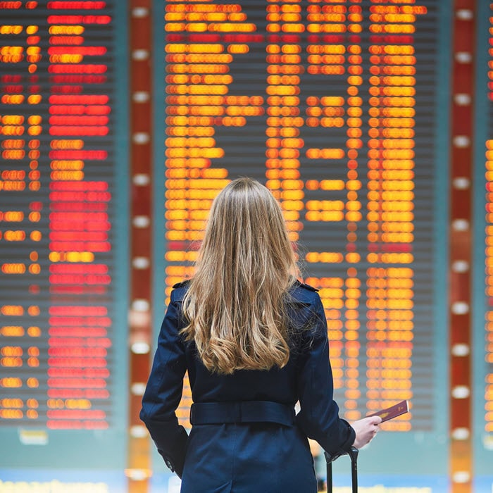 woman at airport announcement board