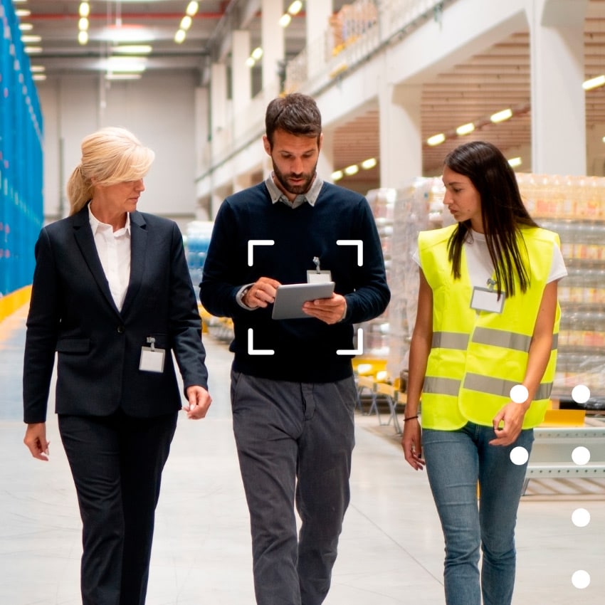 People working in a warehouse on digital device