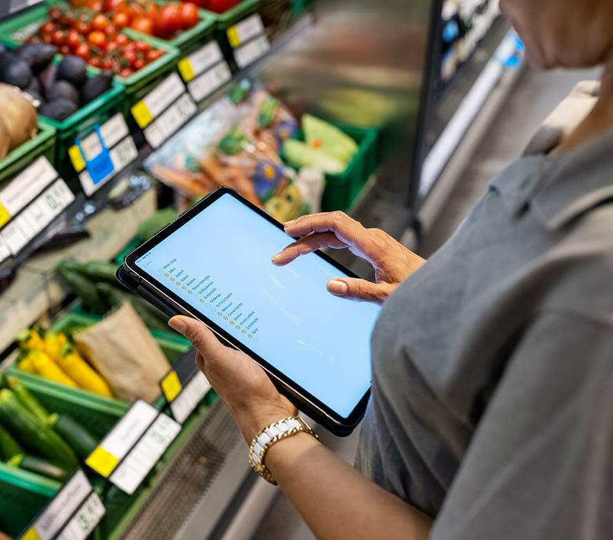Supermarket worker with iPad