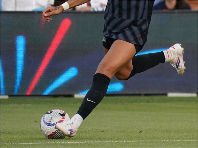 woman dribbling soccer ball