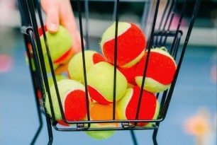 basket full of tennis balls