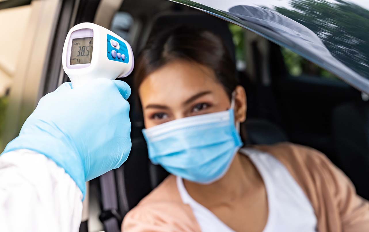 women getting her temperature checked