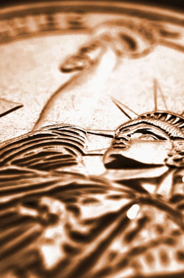 Sepia close-up of statue of liberty on back of coin