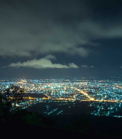 Nightview of city light grid overlooking a valley